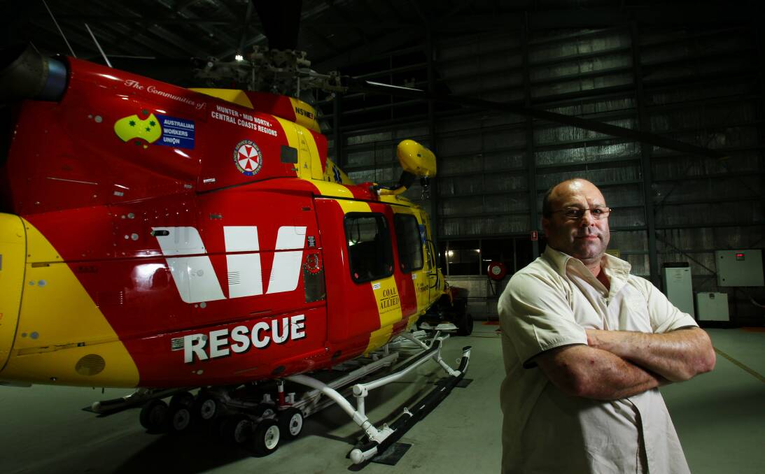 CAPTAIN: Richard Jones with a rescue helicopter at Broadmeadow in 2012. 