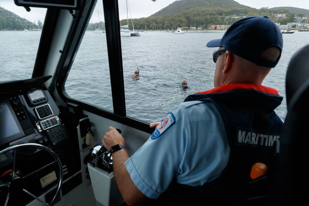Boating safety officer Paul Hearfield speaks with a couple of snorkellers. Picture: Max Mason-Hubers 