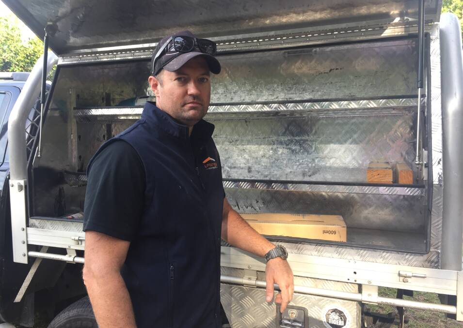 ROBBED: Jason Thomas, from Lifestyle Home Projects, with the empty tool shelves on his ute. Picture: Scott Bevan