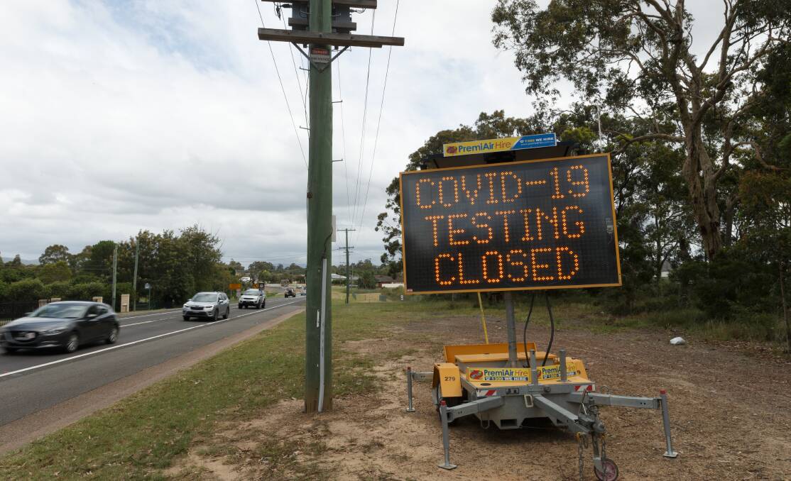 A roadside sign at Heddon Greta, indicating the local testing clinic is closed. Picture: Max Mason-Hubers