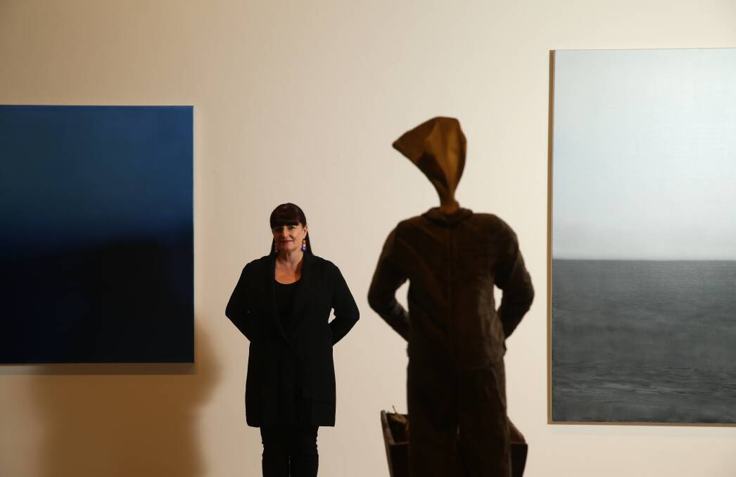THRILLED: Newcastle Art Gallery director Lauretta Morton, standing with a Linde Ivimey sculpture and two Chris Langlois paintings. Picture: Jonathan Carroll