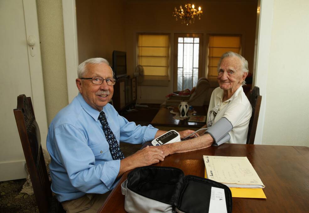 Dr Jon Kochanski visits his oldest patient, 97-year-old Thomas Anderson, at his home. Picture: Jonathan Carroll 
