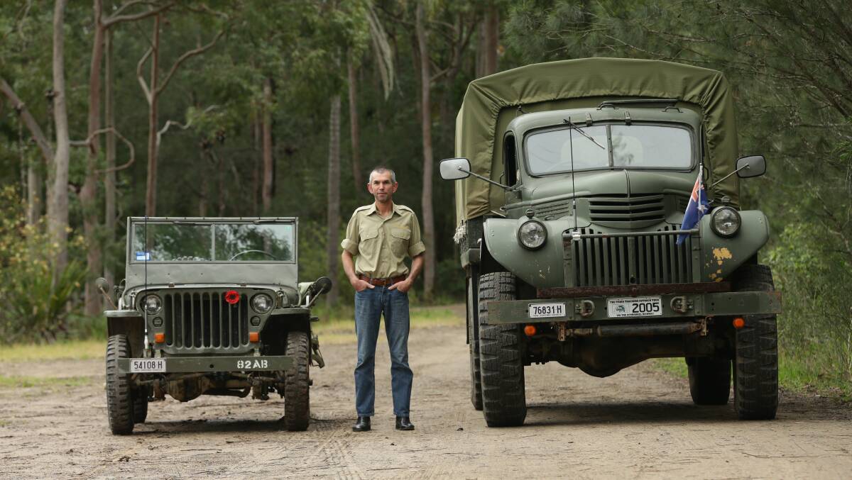 Newcastle Military Vehicle Club member Jason Becker with his historic jeep and truck. Picture: Jonathan Carroll 