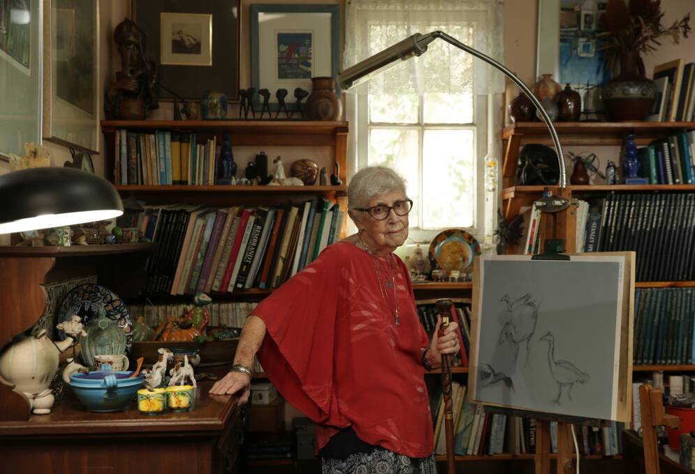 Ruth Uhrig Samuels in her home studio, painting birds she saw at the wetlands. Picture: Simone De Peak 