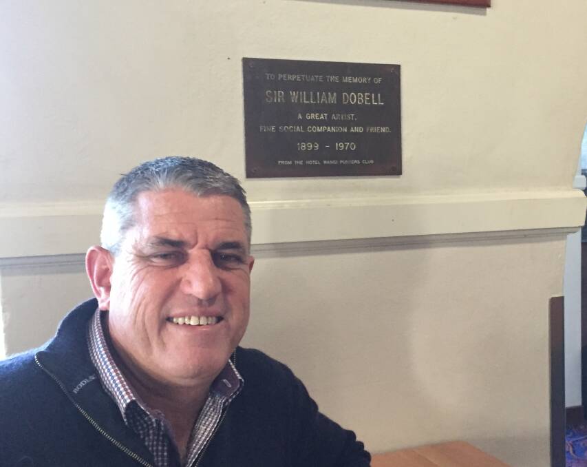 REMEMBERING: Hotel Wangi publican Peter Coyne with the memorial plaque erected by William Dobell's friends. Picture: Scott Bevan