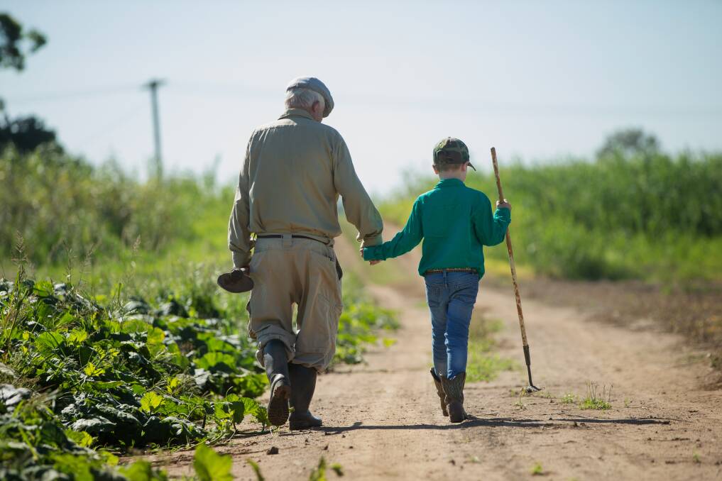 WALKING ON: Dal Osborn, 92, with his seven-year-old great grandson, Dallas, on the family farm at Pitnacree. 