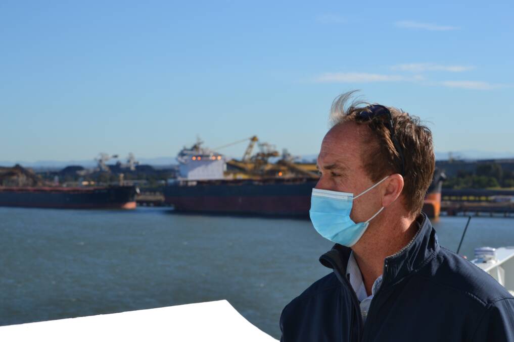 Marine pilot Captain Mark Webb, with ships being loaded with coal at Kooragang in the background. Picture: Scott Bevan