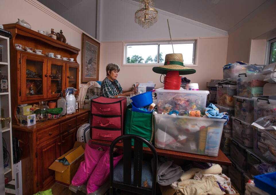 Judith Hopper in her dining room, filled with supplies. Picture: Marina Neil