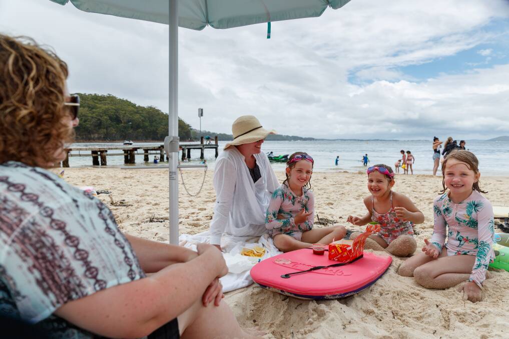Kelly Graham, from Sydney, enjoying a picnic with her two daughters, a family friend and her daughter at Little Beach. Picture: Max Mason-Hubers