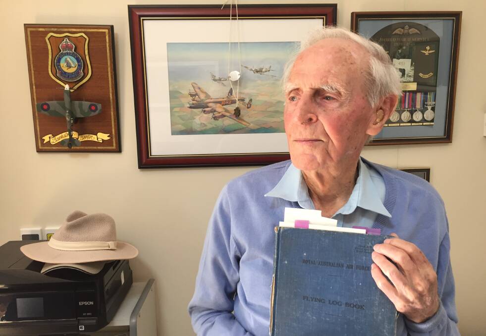 MEMENTO: Former Spitfire pilot Sid Handsaker holding his log book. 