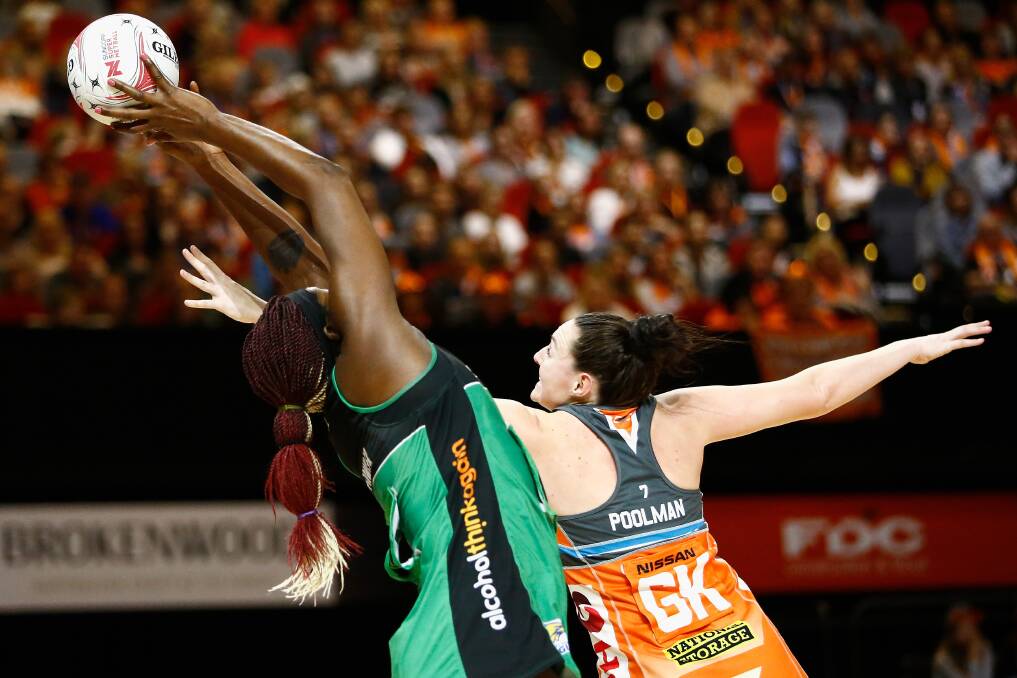 Sam Poolman, playing for the Giants, competes for the ball against a West Coast Fever opponent. Picture: Jeremy Ng, AAP