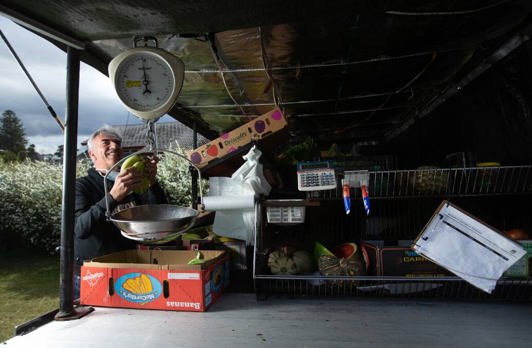 Tom Pandevski weighs fruit at the back of his truck. Picture: Marina Neil