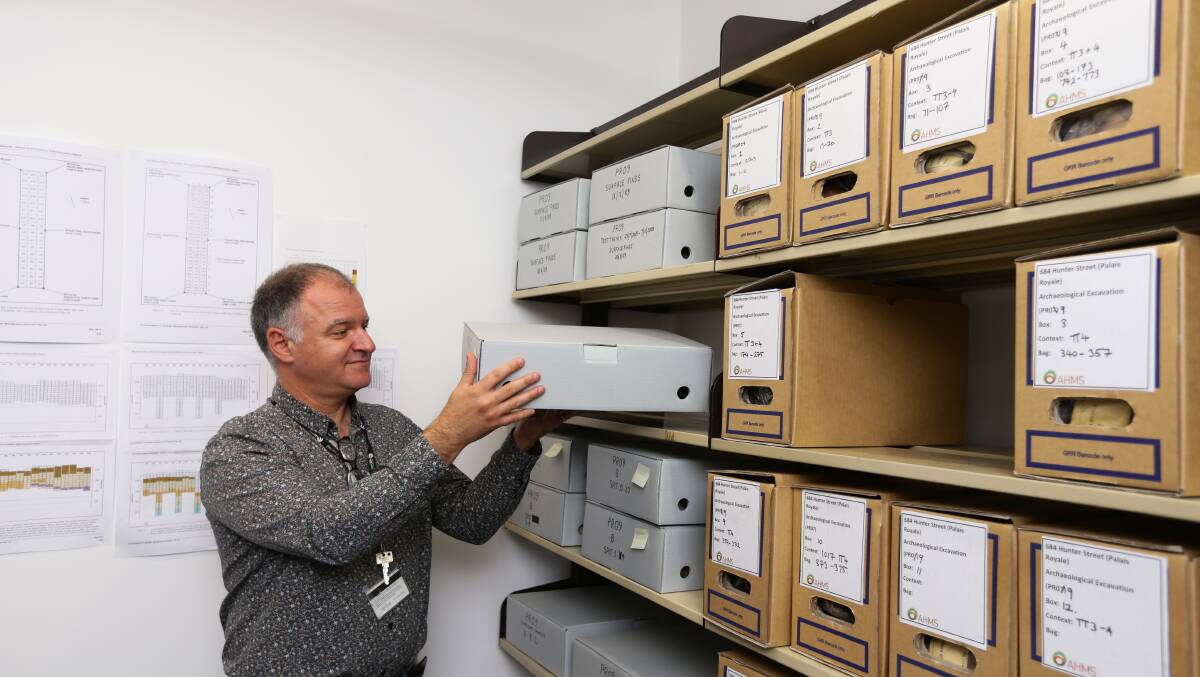 University archivist Gionni Di Gravio with the boxes of artefacts. Picture: Jonathan Carroll