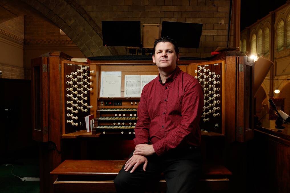 Peter Guy with the organ in Christ Church Cathedral. Picture: Max Mason-Hubers