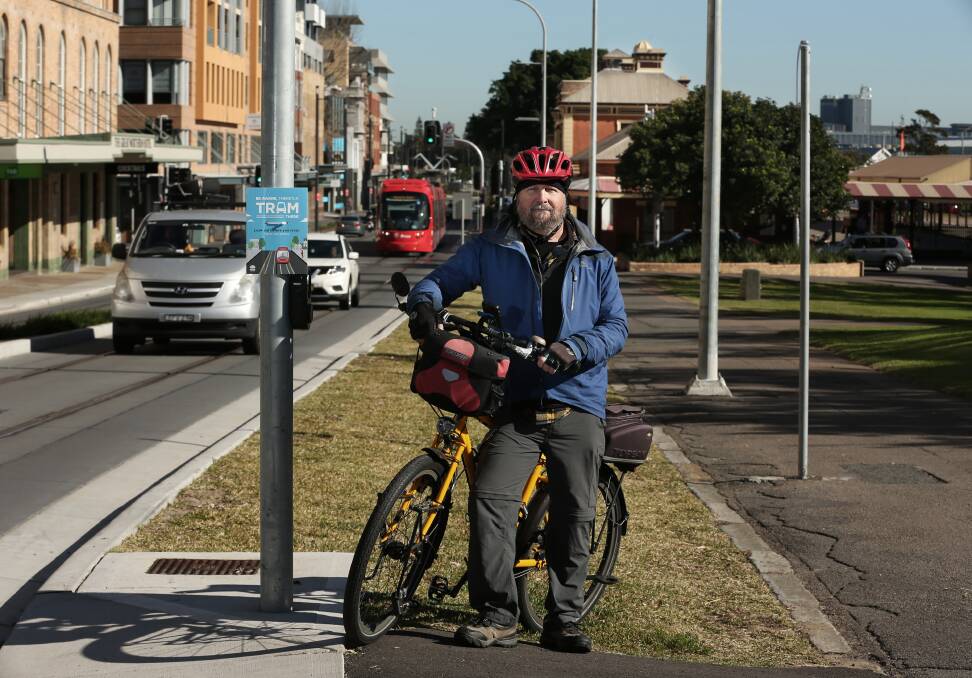CROWDED SPACE: Sam Reich, from Newcastle Cycleways Movement, in Scott Street, where riders share the road with vehicles and light rail carriages. 