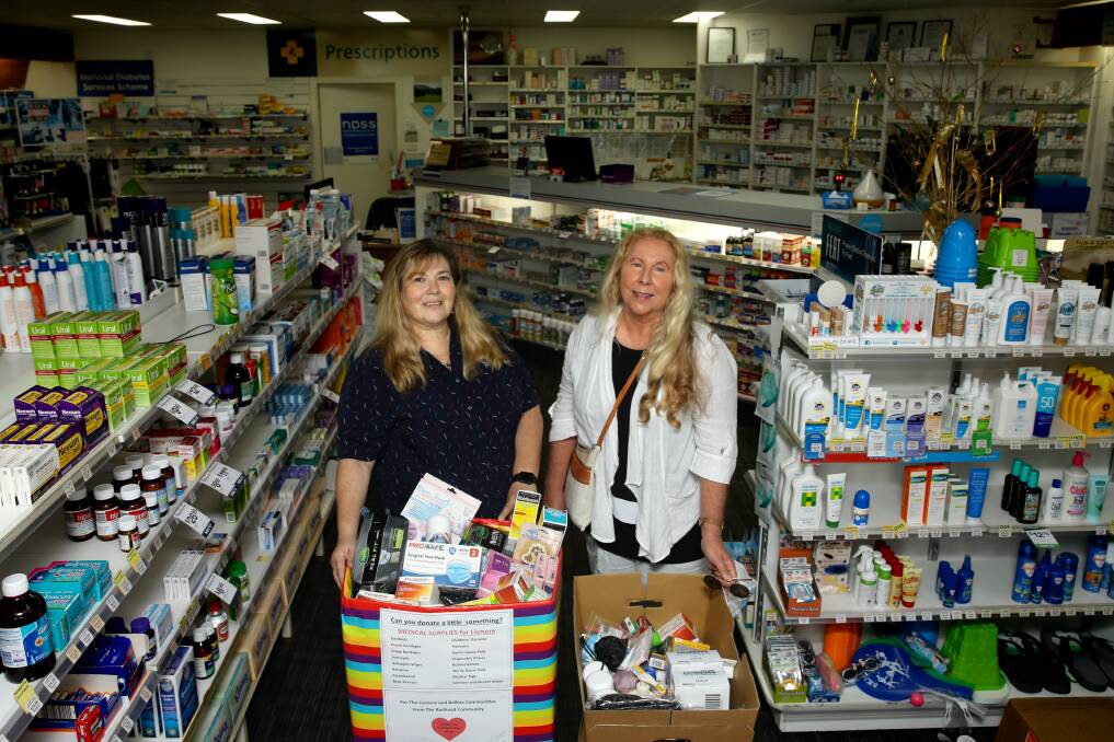 Redhead Pharmacy's Tammy Ball and resident Deb Arthurs with two boxes filled with donated goods. Picture: Jonathan Carroll 