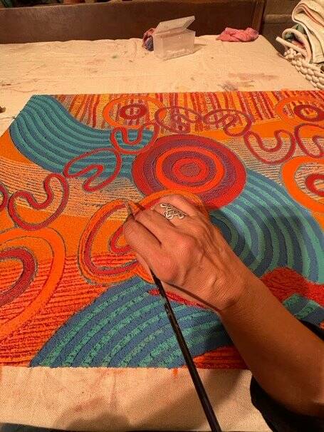 Saretta Fielding working on a painting. Picture: Courtesy, Saretta Art & Design