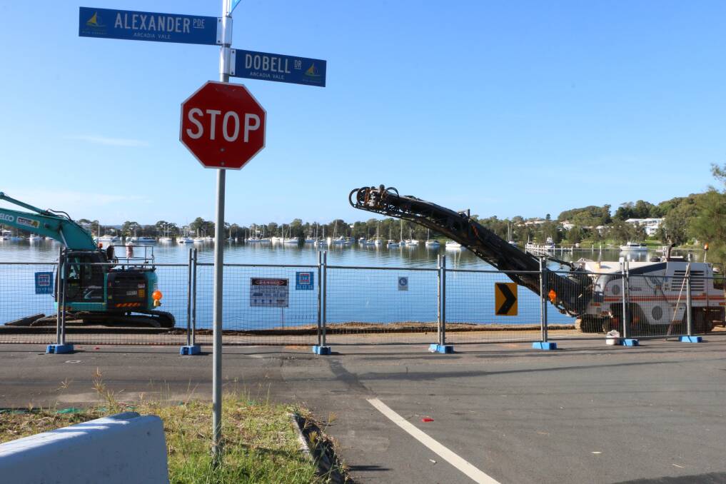 BIG JOB: Work has started on repairing the section of Alexander Parade which collapsed into Lake Macquarie. Picture: Jamieson Murphy