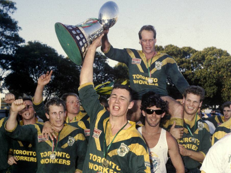 Mal Graham is hoisted by teammates after winning the grand final at Harker Oval in 1991. Picture: Ken Robson