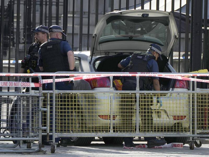 Police at the scene after a car collided with the gates of Downing Street in London. (AP)