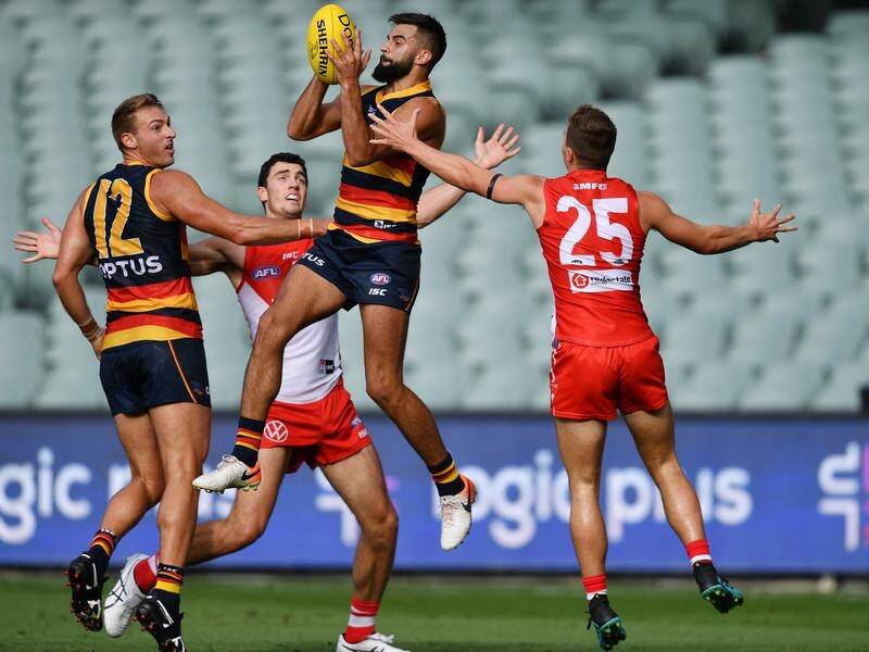 Adelaide's Wayne Milera (c) could miss the entire AFL season after a serious knee injury vs Port.