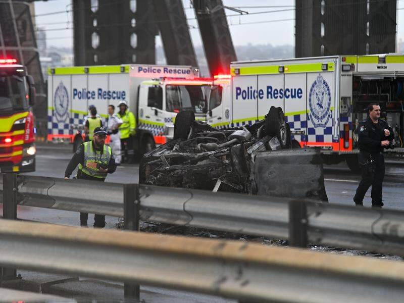 A car burst into flames on the Sydney Harbour Bridge after a multi-vehicle crash.
