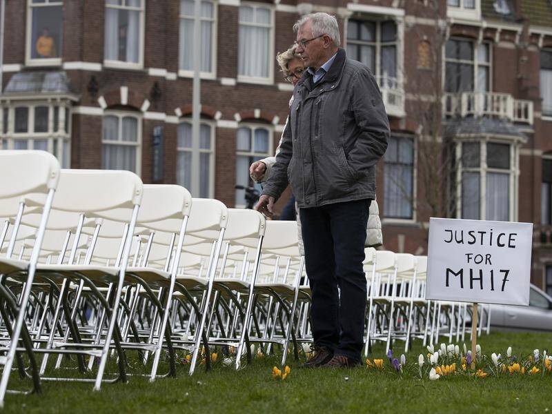 Victims' families set out 298 white chairs for each victim of downed jet MH17 ahead of the trial.