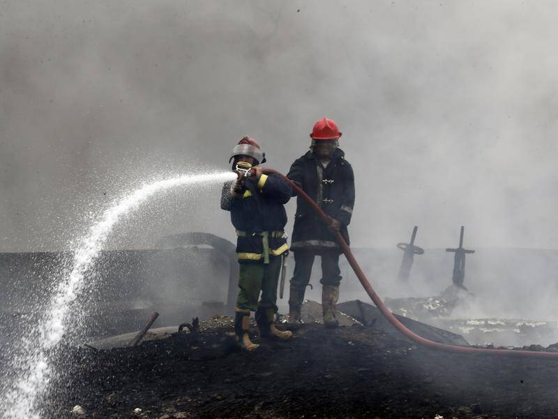 Firefighters have been able to enter the explosion site and douse the smouldering remains. (EPA PHOTO)