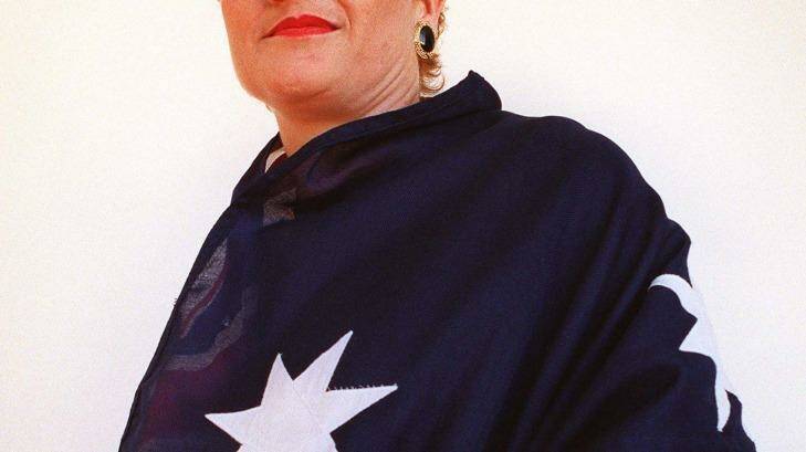 Pauline Hanson stands haughtily draped in the Australian flag after announcing the name of her party, the "Pauline Hanson One Nation Party". Photo: Andrew Campbell