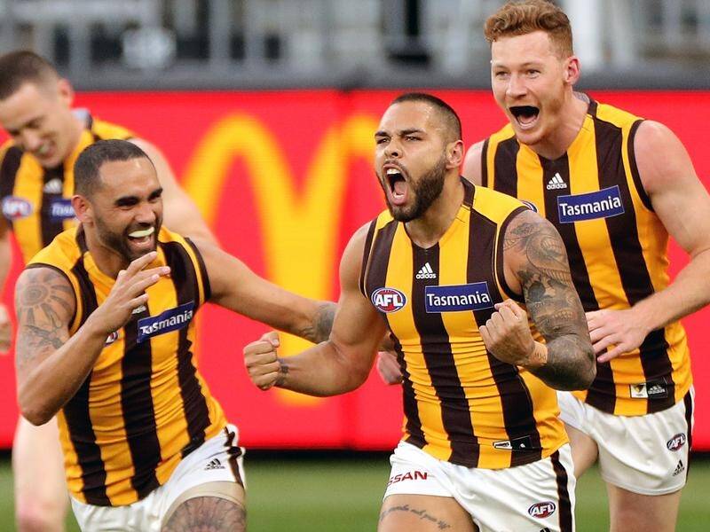 Jarman Impey (c) has scored as Hawthorn came from behind to beat Carlton by 31points in the AFL.