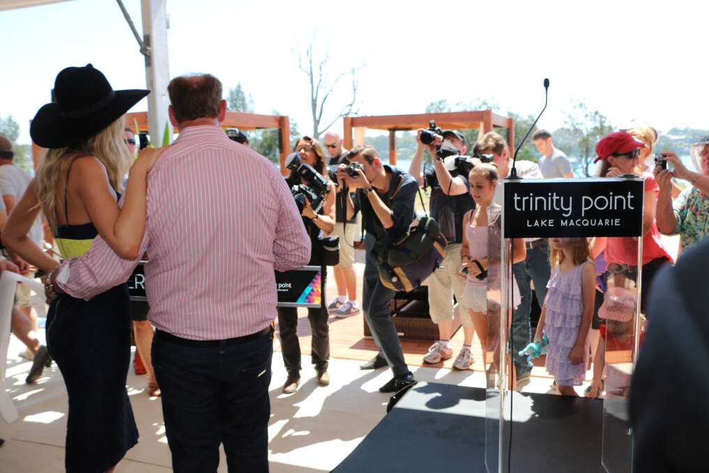 ALL EYES: The media throng and locals jockey for position to grab a picture of Jennifer Hawkins and developer Keith Johnson. Picture: Jamieson Murphy