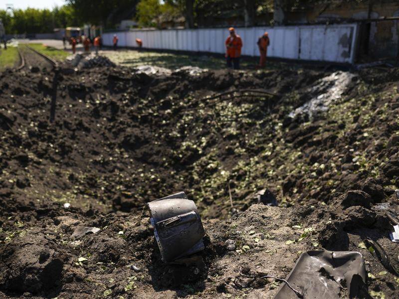A piece of a rocket lies next a crater after a Russian strike in Pokrovsk, eastern Ukraine.