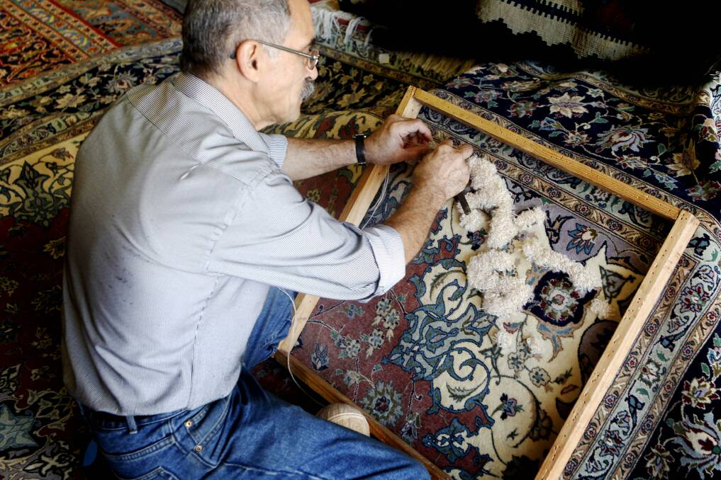 NCH   WEEKENDER ,  Word of Mouth.  Image shows  Ben  from Rahmani's Rugs in Parry street repairing a rug.14th March 2014     pic   Darren Pateman