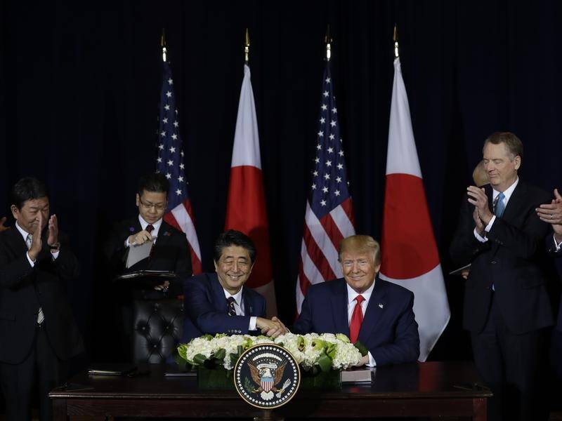 US President Donald Trump and Japanese Prime Minister Shinzo Abe have signed a limited trade deal.