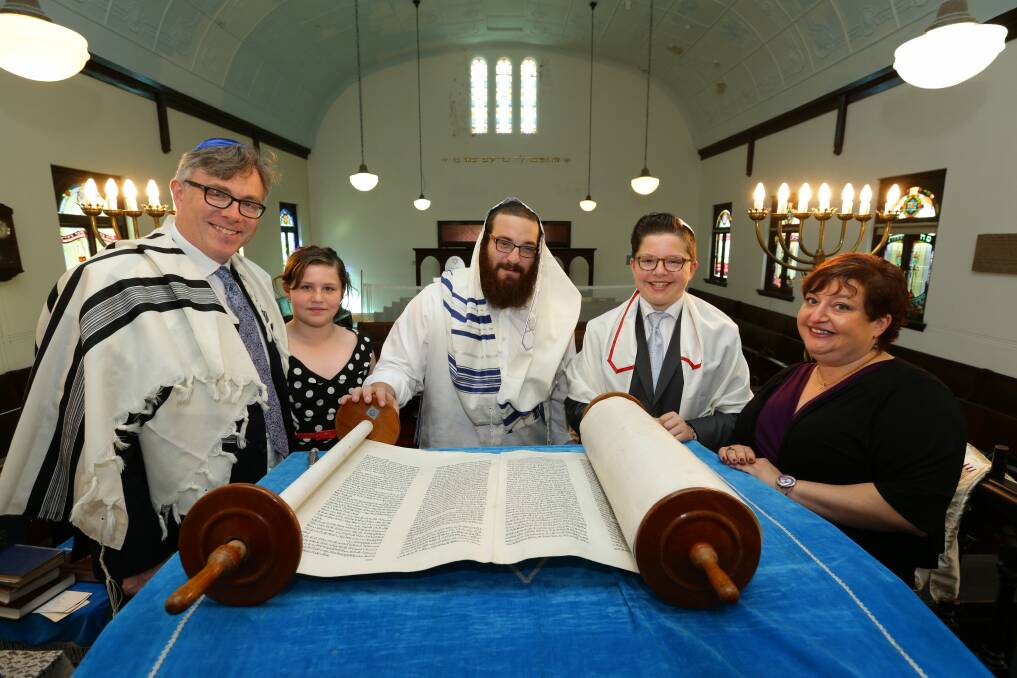 A bar mitzvah re-enactment at the Newcastle Jewish Synagogue. Paul Tipper, Sophia Tipper, Rabbi Yossi Rodal, Joshua Tipper and Claire Tipper.  Picture: Jonathan Carroll