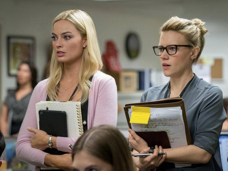 Australian actor Margot Robbie (L) says some of the scenes in the movie bombshell were disturbing.