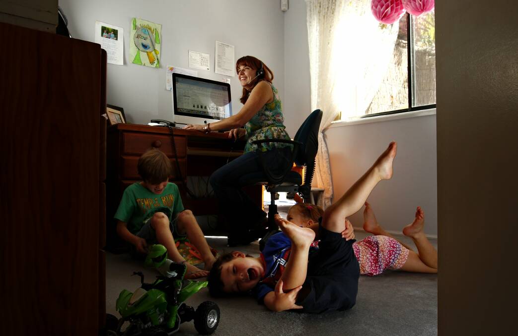 HOUSE CALLS: AAMI staff member Shermaine Fitzgerald in her home office with children Lachlan, 7, Tamika, 5, and Flynn, 3. Ms Fitzgerald, of Gwandalan, says it suits her lifestyle. Picture: Simone De Peak