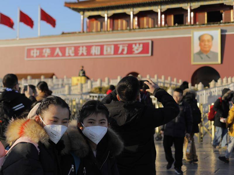 Many Beijing citizens are wearing masks to combat the spread of the mysterious SARS-like virus.