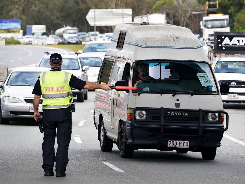 Queenslanders returning home are facing heavy traffic, with delays at NSW border crossings.