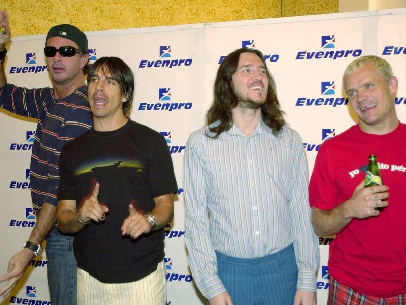 Red Hot Chili Peppers has announced guitarist John Frusciante (2nd R) is rejoining the band.