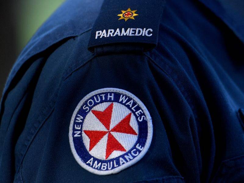 A man is being treated by paramedics after a plane crashed in the NSW Hunter Valley. (Dan Himbrechts/AAP PHOTOS)
