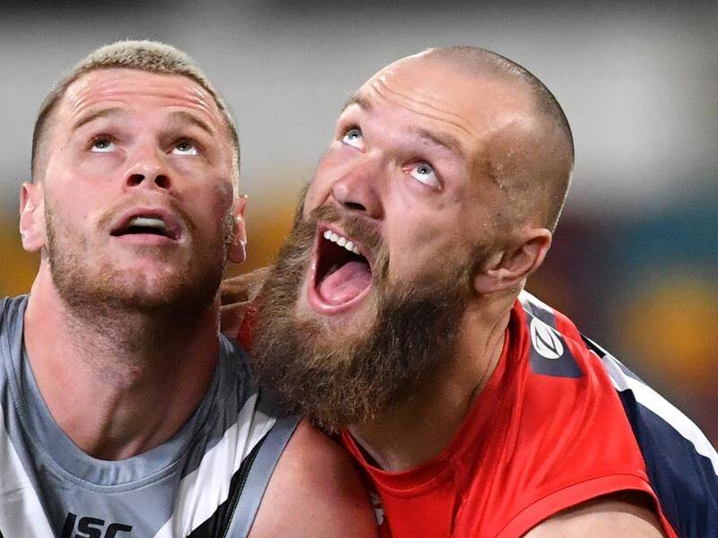 Peter Ladhams (left) of the Power contests for the ball against Max Gawn of the Demons.