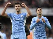 Rodri (l) has signed a three-year contract extension with EPL champions Manchester City.