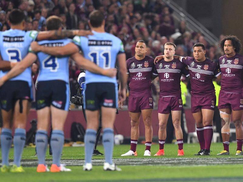 Players from NSW and Queensland during the national anthem ahead of game one of State of Origin.