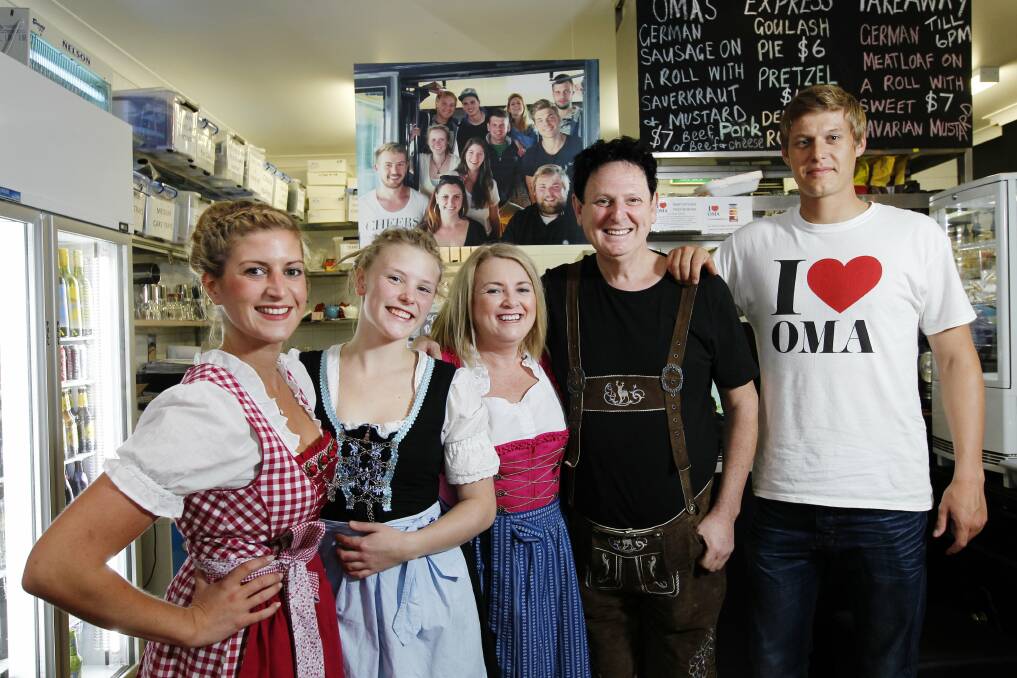 Oma’s Kitchen owners and their staff  with a picture of past staff at a reunion in Germany recently. From left, Lena Beerman, Jonna Bastian, owners Cathy and Mark Fren, and Stephan Gruber.  Picture: Max Mason-Hubers