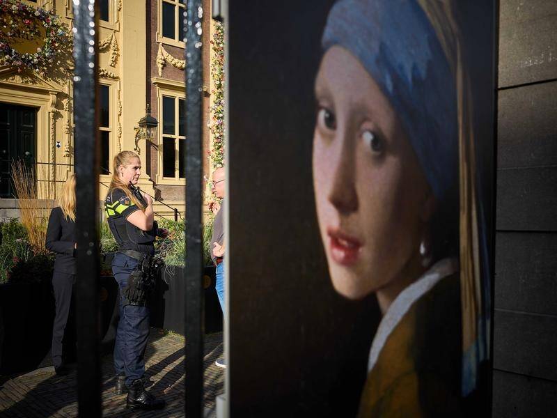 Three people were arrested for attempting to smudge Vermeer's painting 'Girl with a Pearl Earring'. (EPA PHOTO)