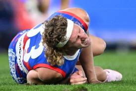 Bulldogs' Aaron Naughton looked in agony after suffering a knee injury in the defeat by the Swans. (Joel Carrett/AAP PHOTOS)