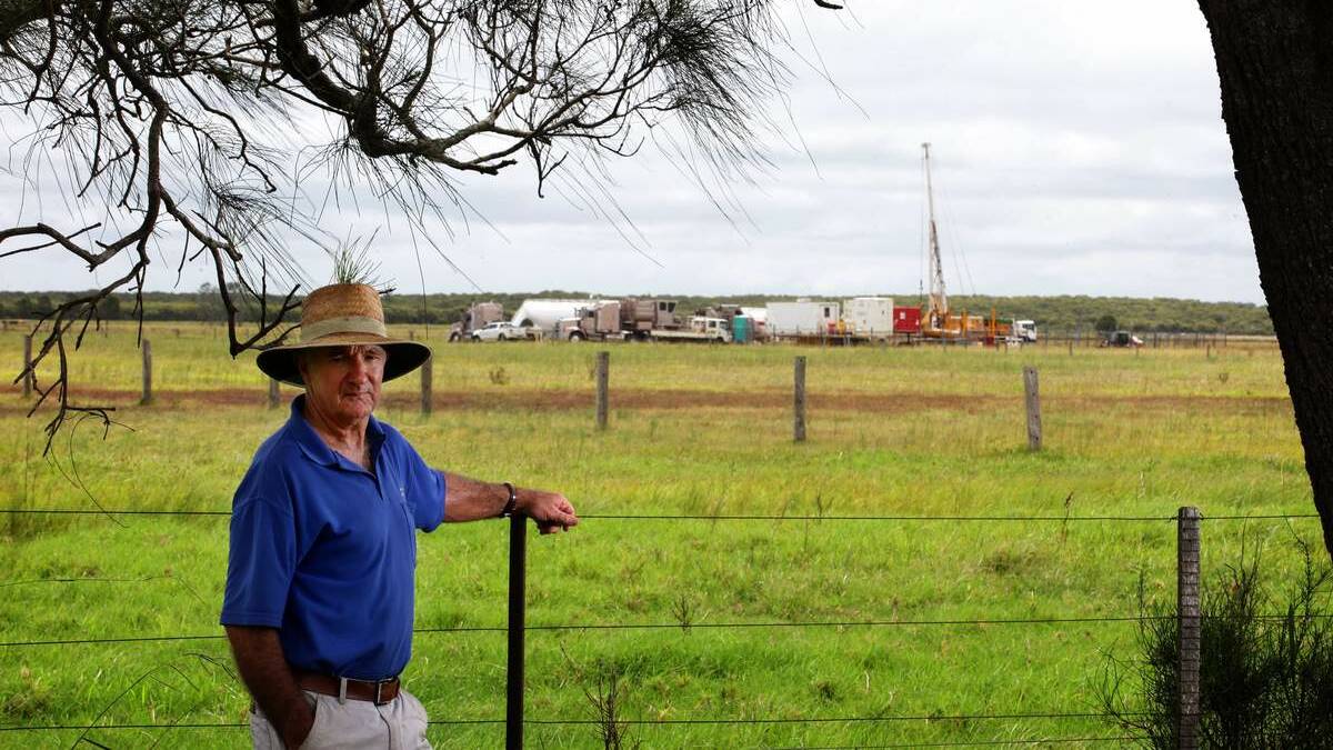 DECOMMISSIONING: Land owner Lindsay Clout at his back fence with the Fullerton Cove Dart Energy CSG site in the background.  Picture: Peter Stoop