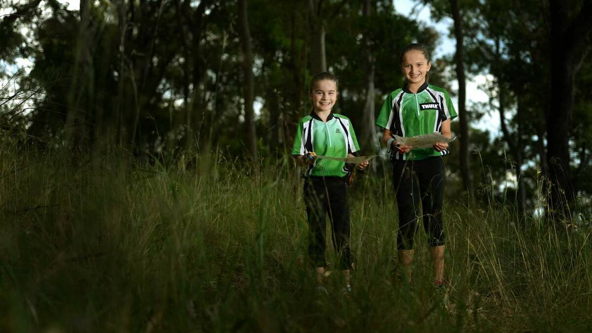 SISTER ACT:  Erika and Mikayla Enderby get their bearings after competing at the Australian orienteering championships. Picture: Marina Neil