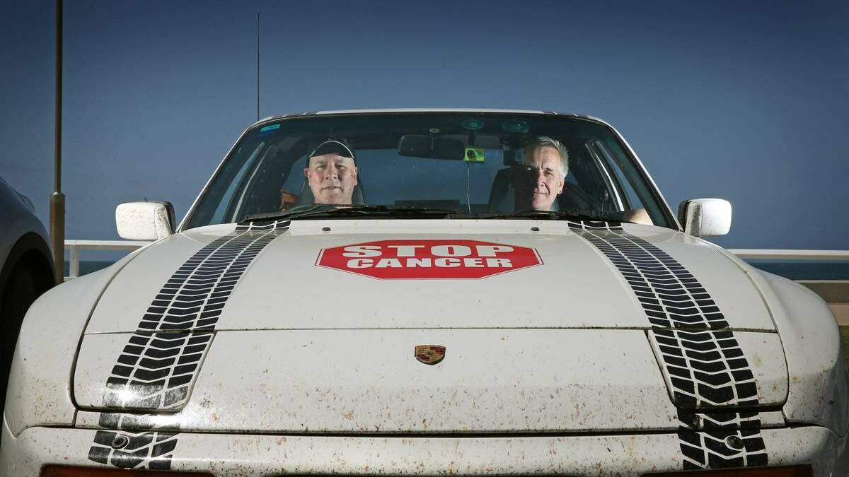 Chris Molloy and David McIntyre, have driven an old Porsche 8500km around Australia to raise funds for charity and they're finishing their drive at Nobbys carpark. Picture: Marina Neil